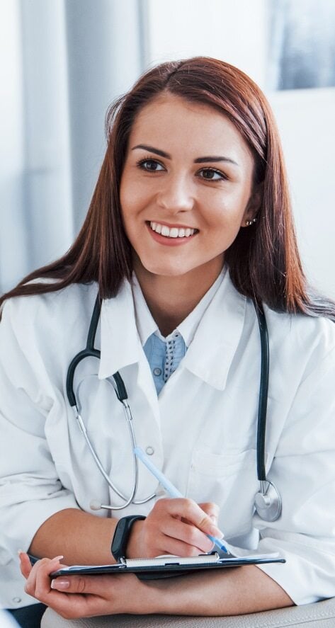 A smiling woman doctor examining a patient.